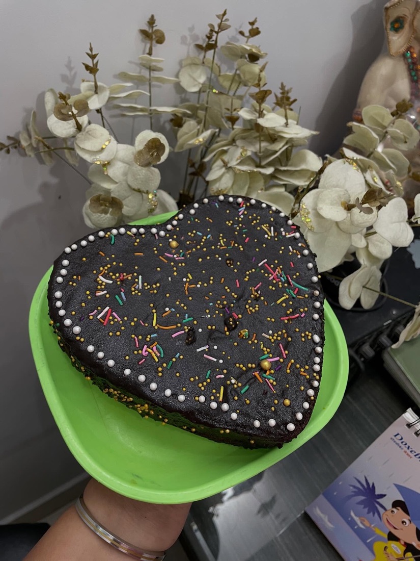A heart-shaped chocolate cake covered in sprinkles
