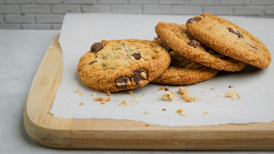 Freshly baked chocolate chip cookies on baking paper